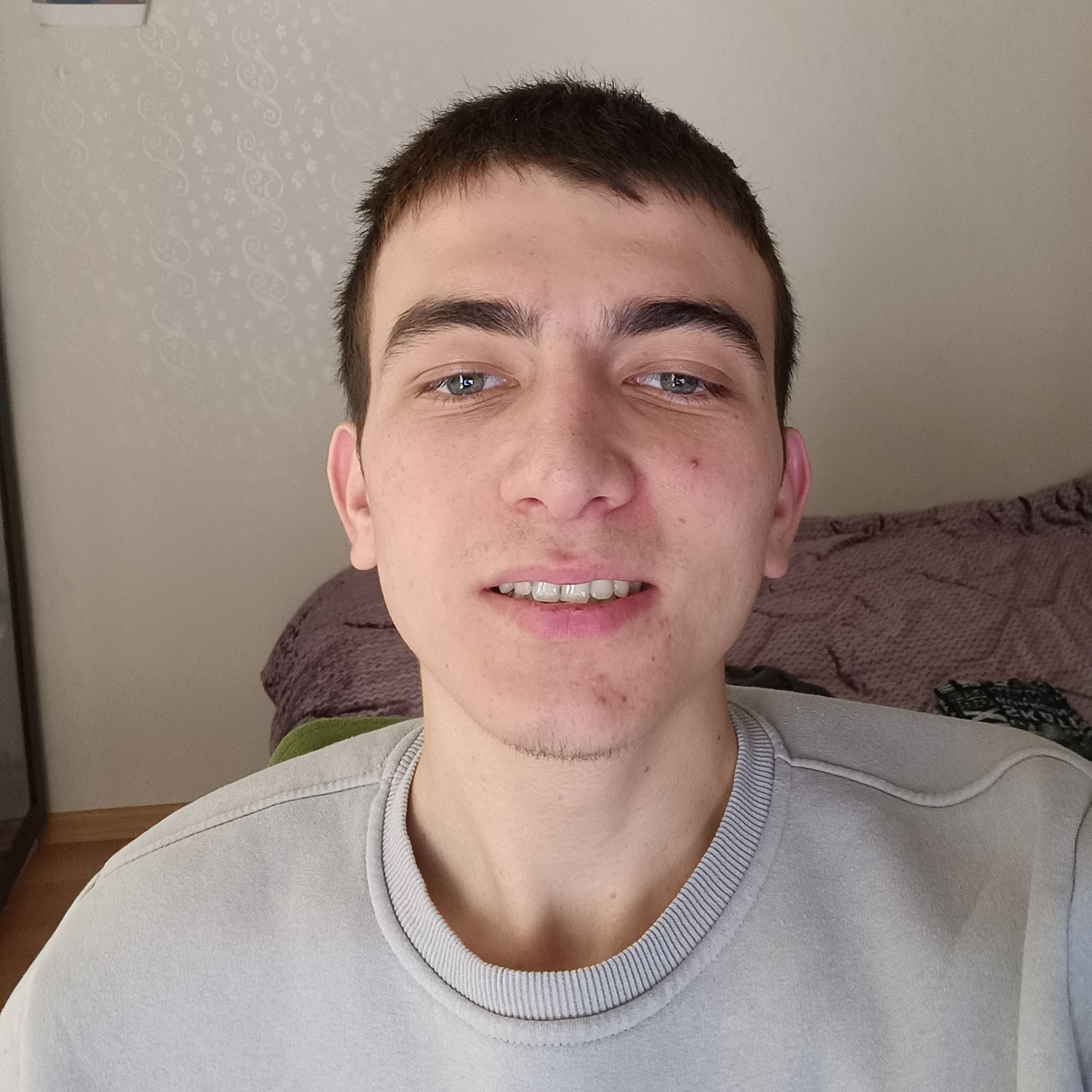 Alperen, a white male, smiles at the camera.